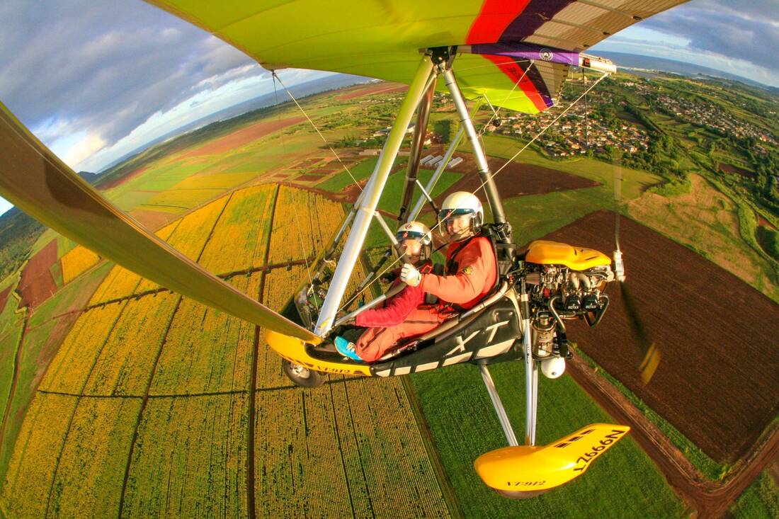Two aboard the trike, patchwork fields far below